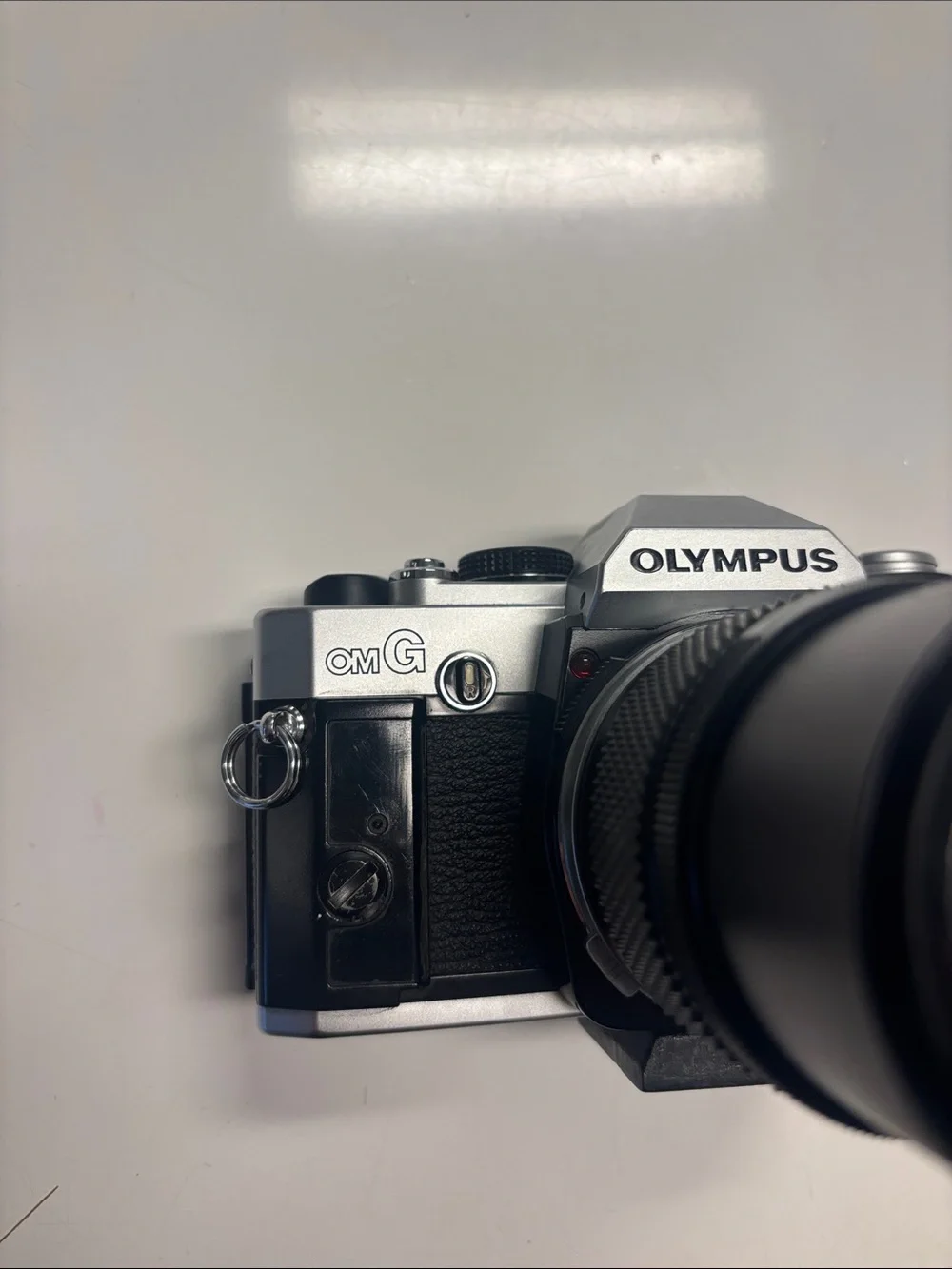 Olympus OM-G Film Camera + 135 mm lens.